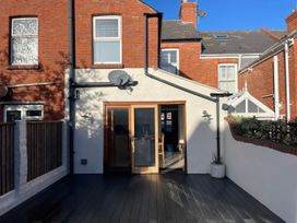 An outdoor area with a door and windows at Owl's Rest in Weymouth