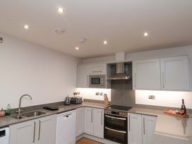 A kitchen with oven and microwave at Apartment 1, 19 Cleveland Terrace in Whitby
