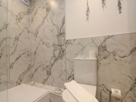 A bathroom featuring a toilet and towel at Apartment 1, 19 Cleveland Terrace in Whitby