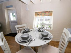 A dining room with a table set for meals at Cobwebs Cold Inn near Saundersfoot