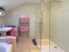 A bathroom with a sink, bathtub, and shower at The Garden Suite at Fiddler Hall Barn, Newby Bridge