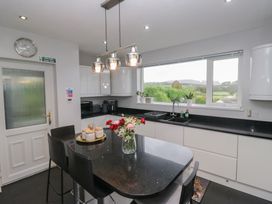 A kitchen with a table, chairs, and a window at Eildon Lodge in Gosforth