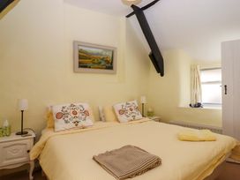 A bedroom with a bed and bedside tables at Fox Hat Cottage in Chagford
