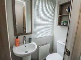 A bathroom with sink and toilet at Trewan Chalet Bryngwran near Rhosneigr