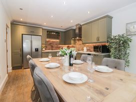 A kitchen with a dining table and chairs at Chestnuts Cottage in Windermere