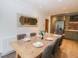 A dining room with a table set for dinner at Chestnuts Cottage in Windermere