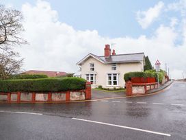 A house with a surrounding hedge and trees at Bryn Offa cottage Holywell