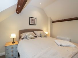 A bedroom with a double bed and bedside tables with lamps at The Old Haberdashery in Swanage