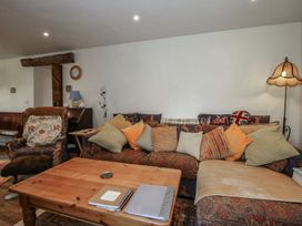 A living room with a sofa and coffee table at Buzzards Breg in Builth Wells