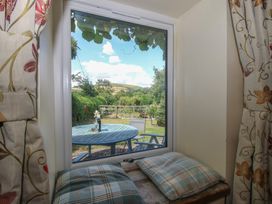 A window view with a garden and seating area at Buzzards Breg in Builth Wells