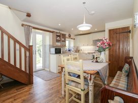 A kitchen with a dining table and a staircase at Buzzards Breg in Builth Wells