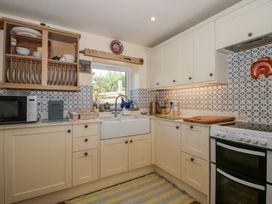 A kitchen with cabinetry and a sink at Buzzards Breg in Builth Wells