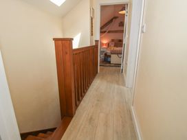 A hallway with wooden railing and doors at Buzzards Breg in Builth Wells