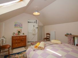 A bedroom with a bed and chest of drawers at Buzzards Breg in Builth Wells