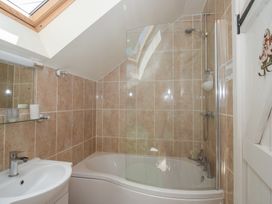 A bathroom with a bathtub and shower at Buzzards Breg in Builth Wells