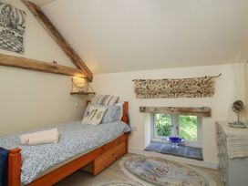 A bedroom with a bed and window at Buzzards Breg in Builth Wells