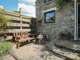A garden with a bench and table outside at Buzzards Breg in Builth Wells