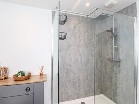 A bathroom with a shower and sink at 3 Tai Newydd Llanfaelog near Rhosneigr