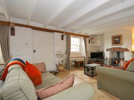 A living room with a sofa and fireplace at Island House in Golant near Tywardreath
