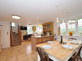 A kitchen with a dining area and staircase at Island House Golant near Tywardreath