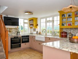 A kitchen with a sink and oven at Island House in Golant near Tywardreath