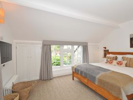 A bedroom with a bed and wardrobe at Island House Golant near Tywardreath