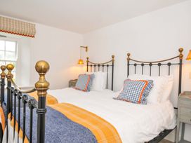 A bedroom with two beds and a window at Island House in Golant near Tywardreath