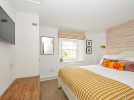 A bedroom with a bed and television at Island House in Golant near Tywardreath