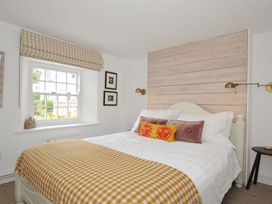 A bedroom with a bed and window at Island House in Golant near Tywardreath