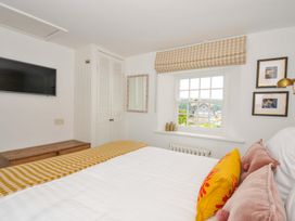 A bedroom with a bed and television at Island House in Golant near Tywardreath