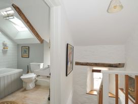 A bathroom with a bathtub and toilet at Island House Golant near Tywardreath