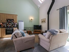 A living room with a sofa and television at No 1 The Granary Capel Coch near Llannerch-Y-Medd