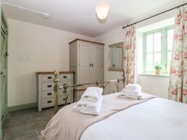 A bedroom with a bed and wardrobe at No 1 The Granary Capel Coch near Llannerch-Y-Medd
