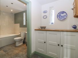A bathroom featuring a bathtub and toilet at No 1 The Granary near Llannerch-Y-Medd
