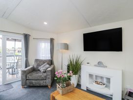 A living room with a sofa and television at The Cotswold Holiday Lodge Evesham