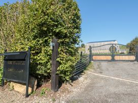 An entrance with a gate and sign at The Hideout County Lodges in Allerston near Thornton Dale