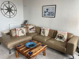 A living room with a sofa and coffee table at Sunrise Apartment in Weymouth