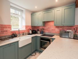 A kitchen with a sink, oven, and microwave at West View in Leasgill near Milnthorpe