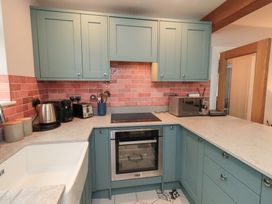 A kitchen with cabinets and appliances at West View in Leasgill near Milnthorpe