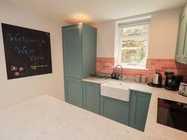 A kitchen with a sink and appliances at West View in Leasgill near Milnthorpe