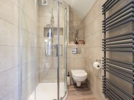 A bathroom with a shower, toilet, and towel rack at West View near Leasgill