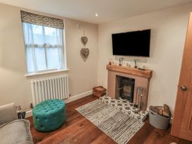 A living room with a television and fireplace at West View Leasgill near Milnthorpe