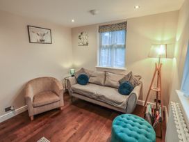 A living room with a sofa and lamp at West View Leasgill near Milnthorpe