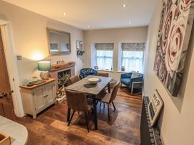 A dining room with a table and chairs at West View in Leasgill near Milnthorpe