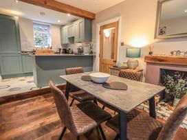 A kitchen with a dining table and chairs at West View in Leasgill near Milnthorpe