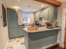 A kitchen with cabinets, countertop, sink and appliances at West View in Leasgill near Milnthorpe