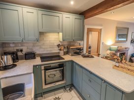 A kitchen with cabinets and appliances at West View Leasgill near Milnthorpe