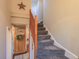 A hallway with stairs and door at West View in Leasgill near Milnthorpe