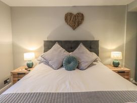 A bedroom with a bed and bedside lamps at West View Leasgill near Milnthorpe