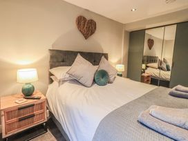 A bedroom with a bed and bedside table at West View in Leasgill near Milnthorpe